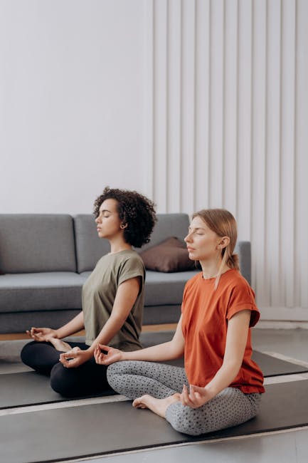 Woman performing a gentle yoga pose in a bright, calm room with natural light